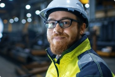 A member of a joint health and safety committee smiles at the camera