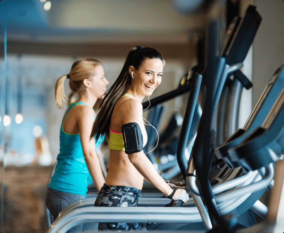 Two women work out in a gym