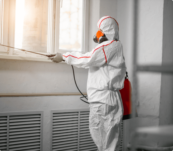 A worker in a hazmat suit performs environmental sampling