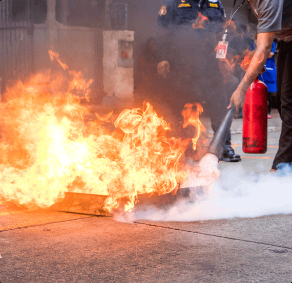An employee puts out a fire with a fire extinguisher